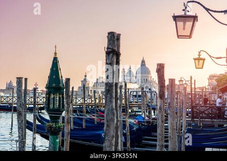 Gondeln bei Sonnenuntergang mit Santa Maria della Salute in Venedig, Italien Stockfoto