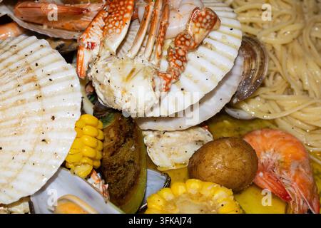 Gegrilltes Meeresfrüchte-Platter mit Krabben, Garnelen, Jakobsmuscheln, Muscheln und Pasta Stockfoto