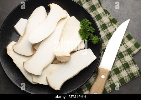 Frische Austernpilze mit Petersilie und Messer auf grauem Tisch, Flat Lay Stockfoto