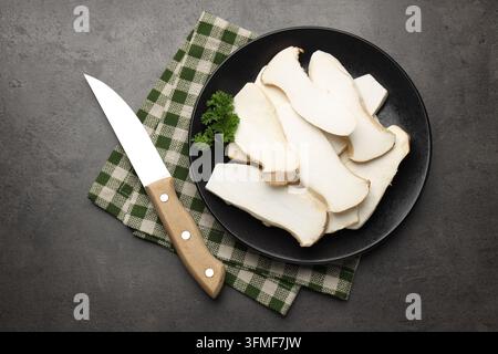 Frische Austernpilze mit Petersilie und Messer auf grauem Tisch, Flat Lay Stockfoto