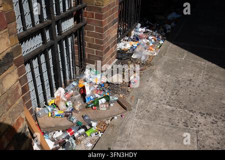 London, England, 13. August 2026. Weite Hochwinkelaufnahme, die Plastikflaschen, Dosen und allgemeinen Müll zeigt, der sich entlang eines Gehwegs angesammelt hat Stockfoto