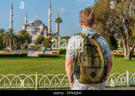 Junger kaukasischer Männertourist mit einem Rucksack vor der Blauen Moschee in Istanbul Stockfoto