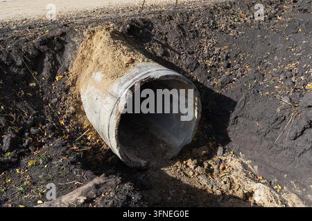 Beton-Sturmwasserabflussrohr, das in einer ausgehobenen Gräben auf einer Baustelle verlegt ist Stockfoto