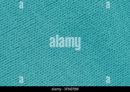 Nahaufnahme von oben auf türkisfarbenen, blaugrünen, gestrickten Wollstoff als Hintergrund mit diagonalem Stichmuster für warme, handgefertigte Winterkleidung. Stockfoto