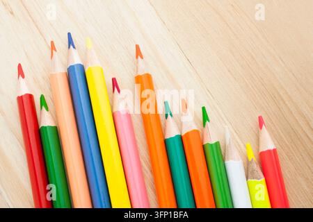 Farbstifte auf einem Holzuntergrund, Zeichnung, Kreativität, Schreibwaren, Bildungs- und Schulbedarfskonzepte. Stockfoto