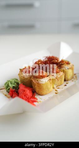 Sushi-Rollen präsentieren köstliche Fusion-Küche mit Meeresfrüchten, Frischkäse und Gewürzen, serviert zum Mitnehmen Stockfoto