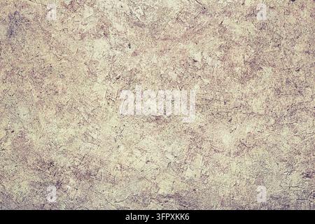 Abstrakter Hintergrund einer gelben Betonsteinwand. Die Textur der Steinoberfläche. Alte abgenutzte Wand Stockfoto