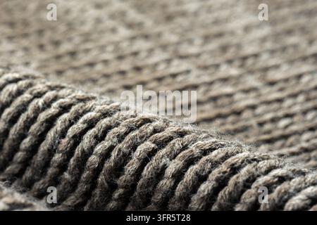 Gestrickte Wollstofftextur mit einem warmen, gemütlichen Muster und natürlichen Fasern, die einen weichen Hintergrund erzeugen Stockfoto