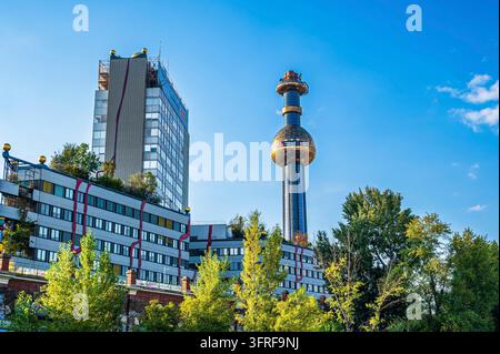 Foto der Spittelau-Müllverbrennungs- und Fernwärmekraftanlage in Wien, Österreich. Das Bild zeigt den markanten goldenen Turm und modernen Postm Stockfoto