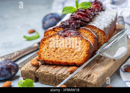 Leckerer Pflaumenkuchen mit würzigen Pflaumen, auf einem Holzservierteller geschnitten, selektive Fokussierung Stockfoto