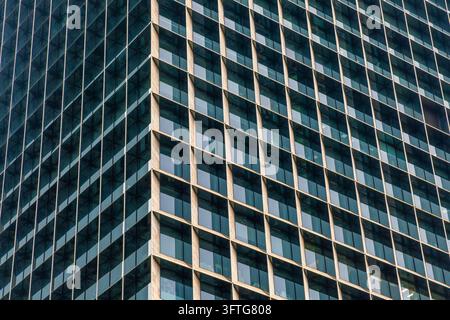 Architektonische Textur, abstrakter urbaner Hintergrund, Fassadenmuster, strukturelle Geometrie. Kantiger Eckpunkt eines modernen Gebäudes in Shenzhen, China, bildet Stockfoto