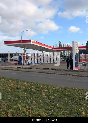Polizisten und Forensikexperten führen eine detaillierte Ortsbesichtigung an einer Esso-Tankstelle entlang der N10-Autobahn durch, nachdem es in Trappes und der benachbarten Gemeinde La Verrière zu einer Schießerei gekommen ist. Bei dem Angriff kam ein Mann ums Leben und vier weitere wurden verletzt, darunter ein 12-jähriges Mädchen, das schwer verletzt wurde. Die französische nationale Staatsanwaltschaft zur Bekämpfung von Terrorismus (PNAT) hat eine Untersuchung eingeleitet, nachdem ein Schütze von einem Fahrzeug aus auf Passanten geschossen hatte, bevor er in der nahe gelegenen Gemeinde Coignières festgenommen wurde. Trappes, Frankreich, 23. Oktober 2026. Foto von ABACAPRESS.COM Stockfoto