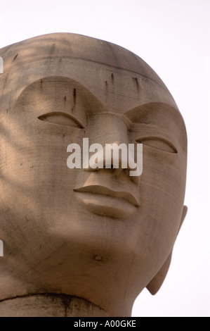 Nahaufnahme einer Kalksteinstatue des Buddha-Schülers Arhat in Bodhgaya, Bihar, Indien. Heitere Steinskulptur Kopf gegen klaren Himmel. Stockfoto