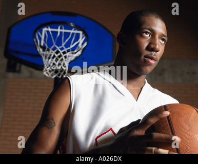 Basketball Spieler halten Ball, Porträt Stockfoto