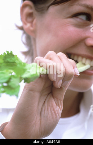 Ehrliches Porträt einer jungen Frau Essen Sellerie Stockfoto