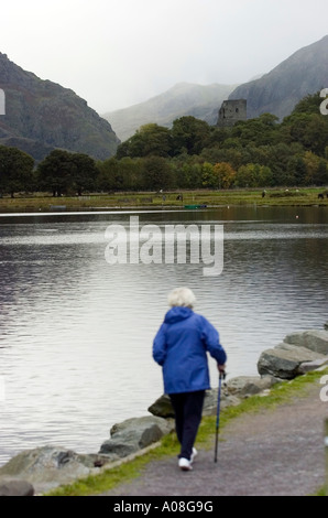 Fuß neben Llanberis Lake mit dem 13. Jahrhundert Dolbadarn Schloss in der Ferne in der Nähe von Berg Stadt von Llanberis. Stockfoto