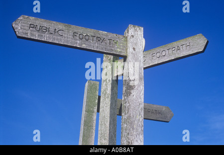 Drei hölzerne Wegweiser Zeichen nahe beieinander klar unter blauem Himmel besagt öffentlichen Fußweg und in 3 verschiedene Richtungen zeigen Stockfoto