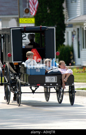 Amische Kinder im hinteren Trailer von einem Pferd und Buggy Combo in Shipshewana Indiana. Stockfoto