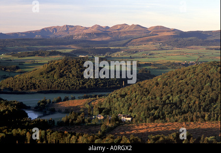 Blick auf Les Monts Dore Vulkane des Parc Naturel Regional des Vulkane d ' Auvergne mit Chateau de Montlosier im Vordergrund Stockfoto