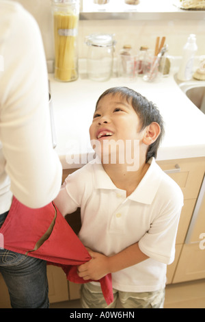 Erhöhte Ansicht eines jungen, der neben seiner Mutter in der Küche Stockfoto