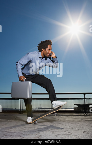 Geschäftsmann auf einem skateboard Stockfoto