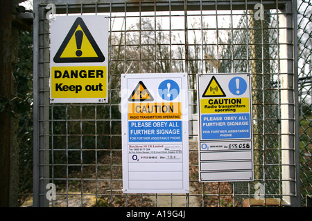 Warnhinweise auf der Umzäunung von einem British Telecom (BT) Telekommunikation Turm, Henham, Essex, England. Stockfoto