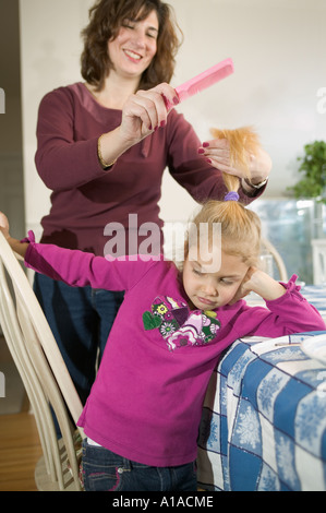 Haare kämmen Tochter Mutter Stockfoto