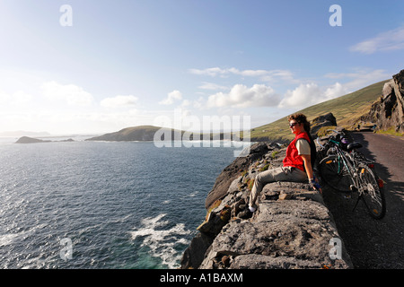 Eine weibliche Radfahrer genießt die Sonne, Slea Head, Halbinsel Dingle, Kerry, Irland Stockfoto