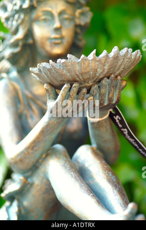 Messing Feenstatue sitzen und halten Blumen Schale Stockfoto