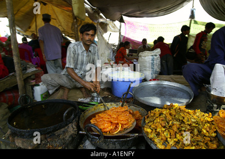 Mann Braten Süßigkeiten an Dussehra fair mit enormen Vielfalt an reiche indische Küche Mahlzeiten, Kullu, Indien Stockfoto