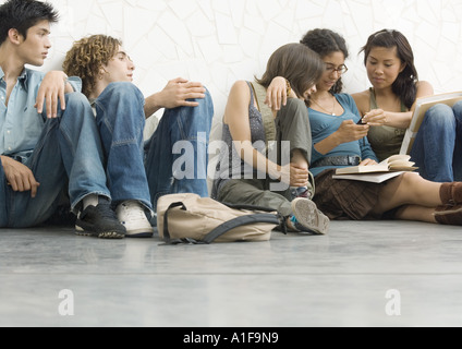 Gruppe von Studenten, die auf dem Boden sitzend Stockfoto