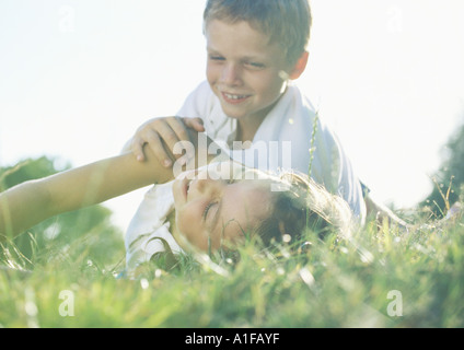 Jungen und Mädchen spielen in Rasen Stockfoto