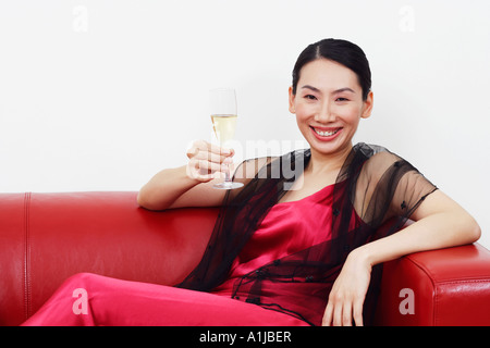 Porträt einer Mitte erwachsenen Frau hält ein Champagnerglas und lächelnd Stockfoto