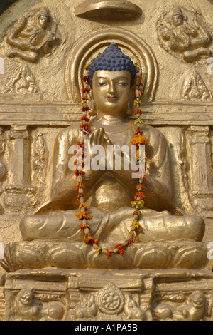 Eine Buddha-Statue ist mit einer Blumengirlande in der Nähe der Mahabodhi-Tempel in Bodhgaya in Bihar in Indien eingerichtet. Stockfoto