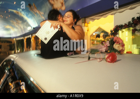 Ein paar Umarmung, nachdem sie bei einer Fahrt durch Hochzeit in ein wenig White Wedding Chapel in Las Vegas Nevada USA geheiratet haben Stockfoto