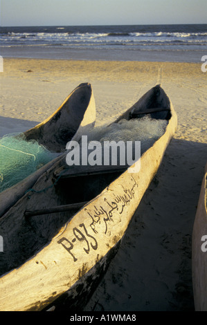 GESCHNITZTE KANUS MIT ANGELN AM STRAND AUF HOHER SEE UFER NETZE Stockfoto