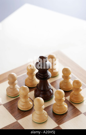 Schach Spiel, schwarzen König umgeben von weißen Bauern Stockfoto