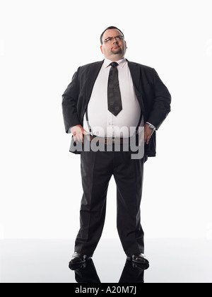Übergewichtiger Geschäftsmann stehend mit Händen auf den Hüften Stockfoto