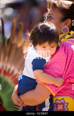 Jingle Dress Tänzerin hält ein Baby Chumash Inter Tribal Powwow Santa Ynez Valley in der Nähe von Santa Barbara Kalifornien Stockfoto