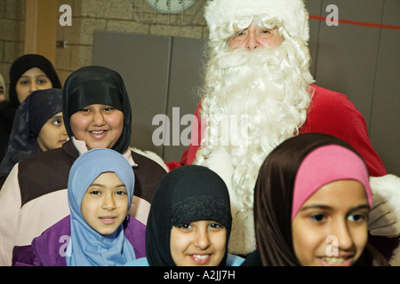 Santa besucht muslimischen Migrantenkinder Stockfoto