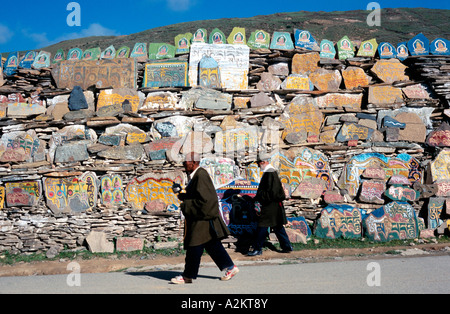 Lokale Männer, die ihre frühen Morgengebet Runden vorbei Mani Steinen Chöde Gompa Kloster Lithang. Stockfoto