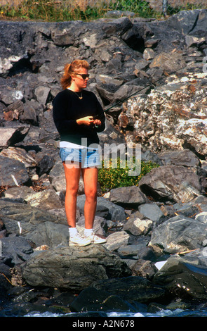 Frau, die Fischerei auf Lachs aus Felsen Seward Alaska USA Stockfoto