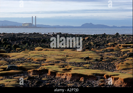 Der felsige Strand von Longniddry Bents mit Cockenzie Power Station im Hintergrund in der Nähe von Edinburgh Stockfoto