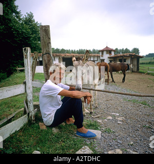 Mann und Esel VOR EINEM PFERDESTALL BASKENLAND FRANKREICH EUROPA Stockfoto