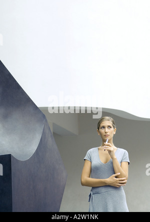 Frau stand neben Skulptur, Pferch bis zum Kinn Stockfoto
