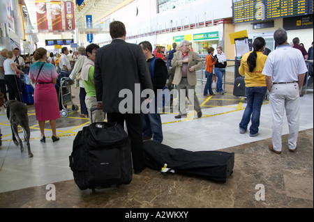 Geschäftsmann mit Gepäck spricht für Urlauber im Ankunftsbereich Reina Sofia Sur TFS Süd Flughafen Teneriffa Stockfoto