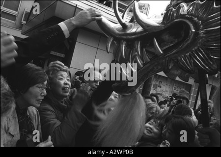 Besucher der Senso-Ji-Tempel in Asakusa Bezirk von Tokio versuchen, den Kopf einer ornamentalen Drachen als Glücksbringer zu berühren Stockfoto