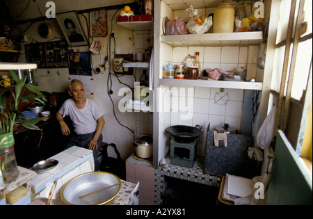 Mann in seiner kleinen Küche im öffentlichen Wohnungsbau Schema in Kowloon Hong kong Stockfoto