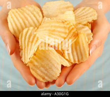 FRAU HOLDING CRINKLE GESCHNITTEN CHIPS / CHIPS Stockfoto