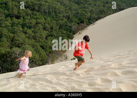 Junge und ein Mädchen klettern die Pyla große Sanddüne in Frankreich Aquitanien Stockfoto